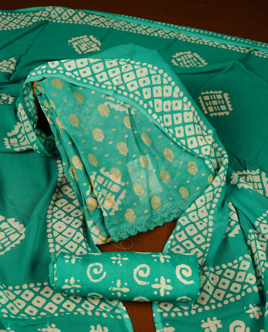 Mint green colour churidar material featuring elegant gold butta work on the front panel, paired with a printed dupatta and matching bottom.