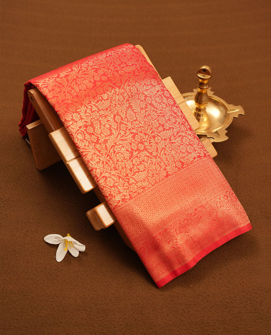 Red colour semi silk brocade saree featuring intricate Gold patterns across the body, complemented by a Self colour woven border and pallu, paired with a matching blouse.