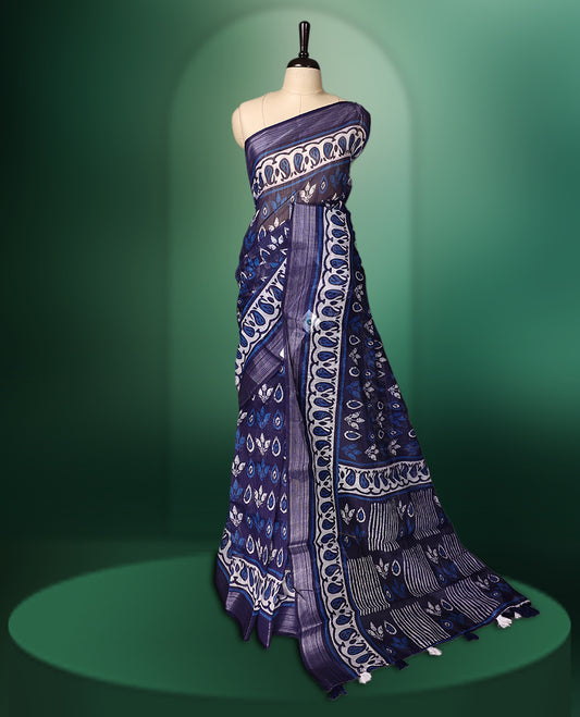 Navy Blue colour cotton saree featuring traditional white and blue hand block prints across the body, highlighted with artistic motifs and a contrasting patterned border, paired with a matching blouse.