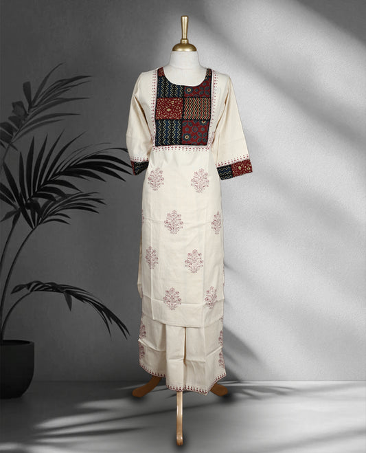 Cream colour cotton cord set with maroon floral prints, highlighted by vibrant patchwork on the yoke and sleeve borders, Paired with matching straight pants.