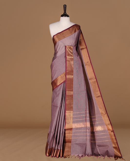 Bronze colour Chettinad Cotton saree featuring elegant plain body, complemented by contrast maroon colour with gold zari border, paired with matching blouse piece.