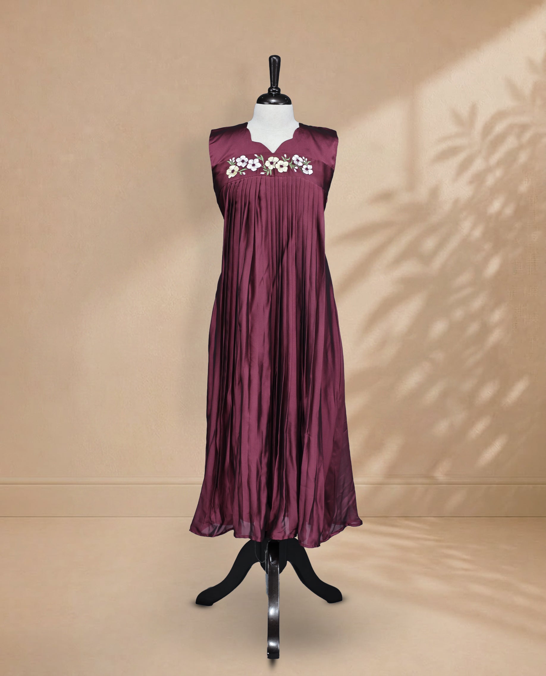 Wine Berry Coloured Sleeveless Kurti Featuring a Designed Neckline, Floral Embroidery on the Body