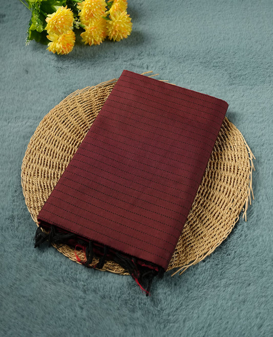 Dark Red colour poly cotton saree with black vertical dotted line pattern on the body, paired with a matching pallu featuring black zigzag geometric border, and a coordinated all‑over black stylised fleur‑de‑lis printed blouse piece.