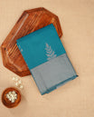 Teal blue colour silk cotton saree featuring ash blue colour thread motifs on body thread detiled contrast borders & pallu,comes with matching blouse piece