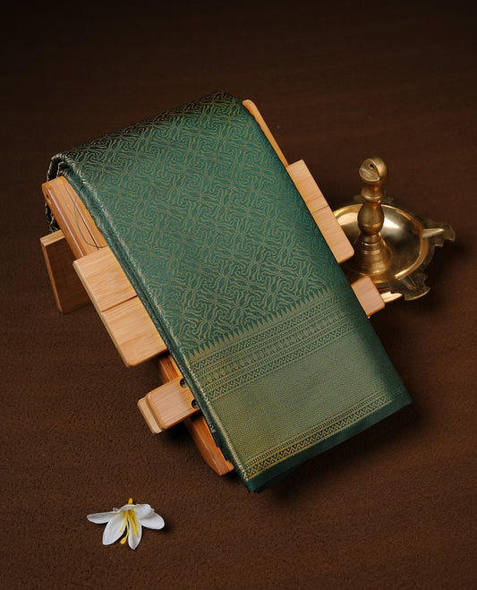 Bottle Green colour Semi Wedding silk saree featuring gold zari kodi pattern across body, complemented by self colour with traditional border, paired with matching blouse piece.