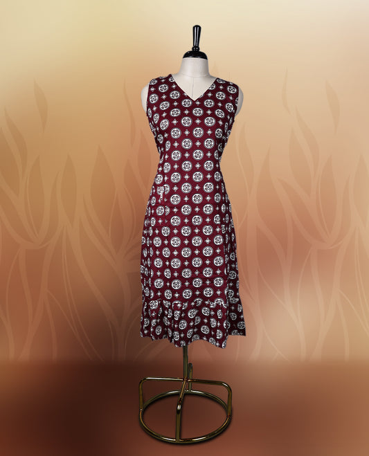 Dark maroon colour sleeveless nightwear with intricate beige and black floral prints in circular patterns, Designed with a V neckline, this kurthi comes with matching fabric sleeves included for a versatile look.