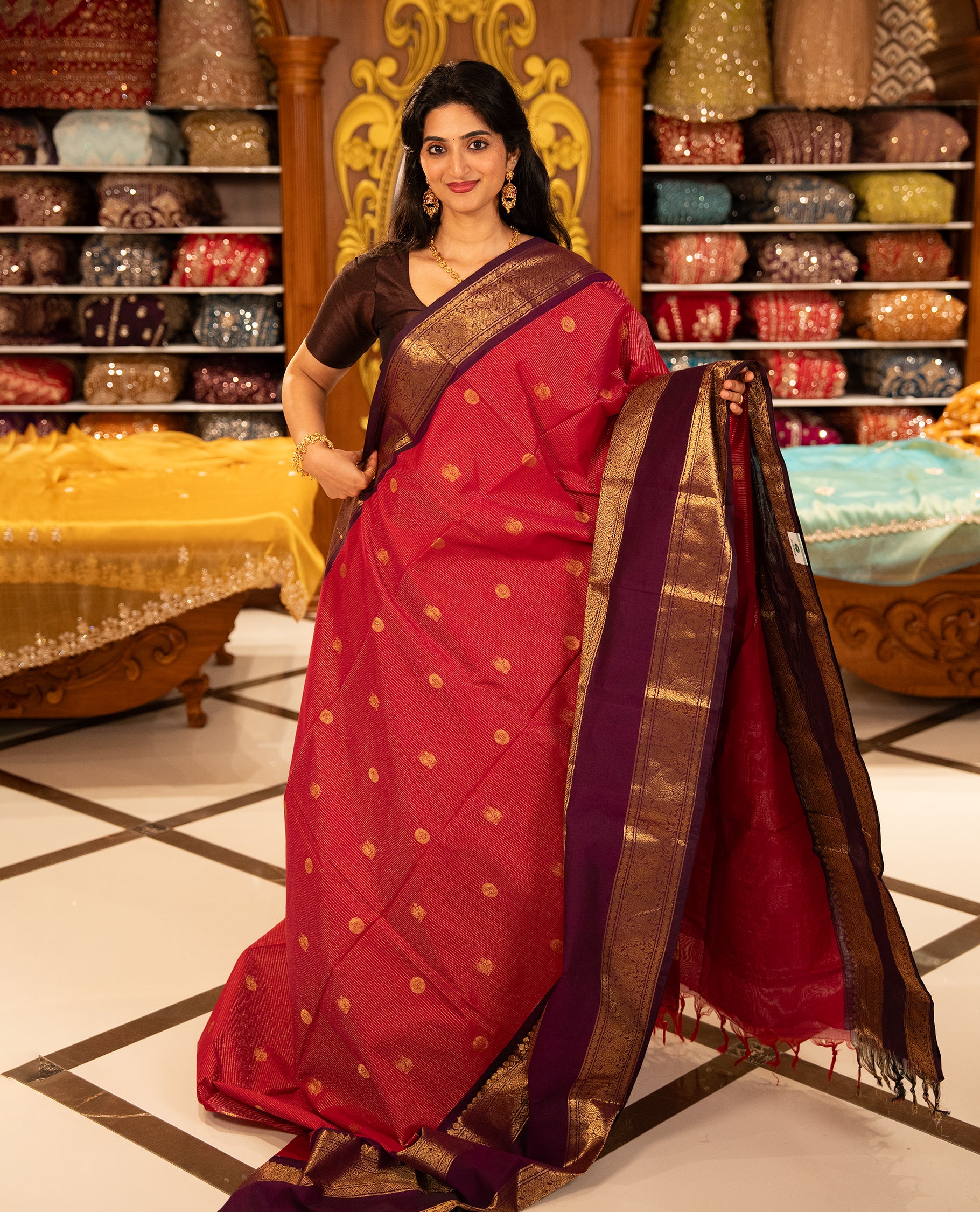 Magenta with Purple Chettinad cotton saree featuring Gold zari strips with peacock motifs on body, complemented by contrast colour border with zari design & grand pallu, comes with matching blouse piece.