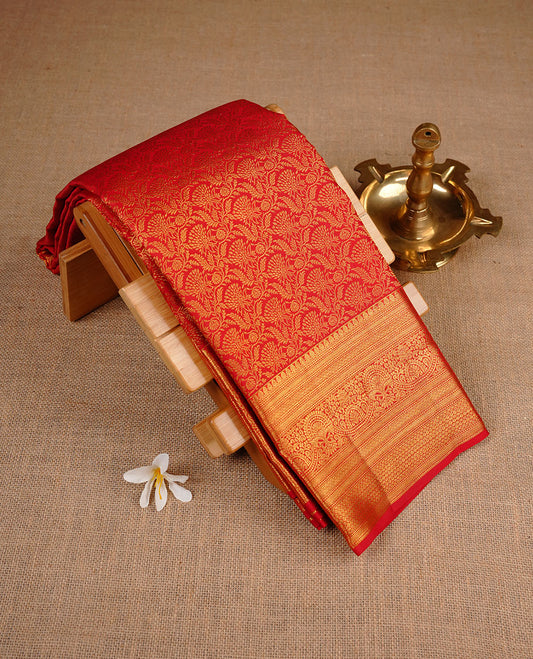 Red colour kancheepuram silk saree featuring gold zari pattern across body, complemented by selfcolour border traditional zari border, paired with matching blouse piece.