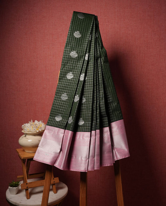 Black colour semi silk saree highlighting silver zari check pattern  and motifs across body, featuring contrast baby pink colour border with silver zari pattern, comes with matching blouse .