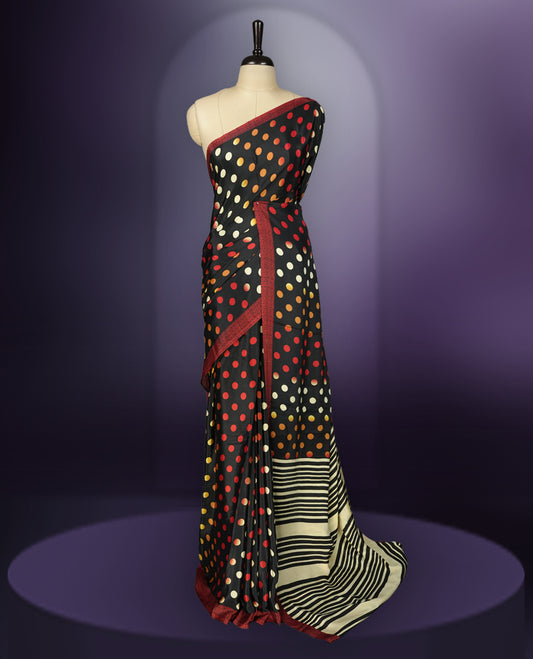 Black colour saree with with large big polka dots on the body, self stripped pallu & Comes with a stylish matching blouse.