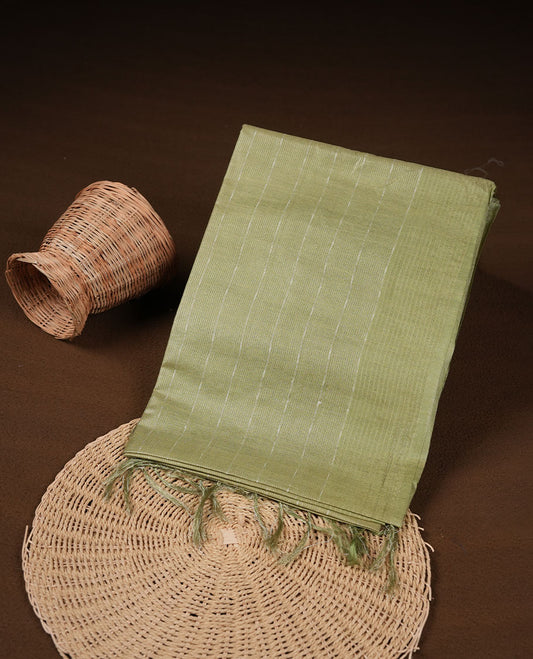 Pastel green colour semi jute saree highlighting gold zari striped body, without border and paired with matching blouse.