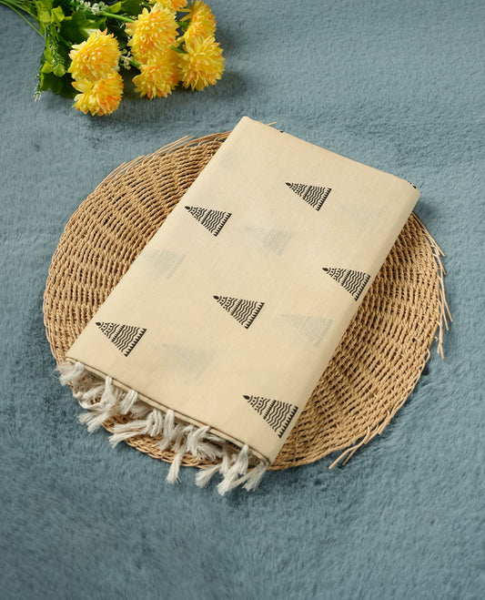 Cream colour poly cotton saree with black temple motifs on the body, paired with a matching with black woven traditional border, and a coordinated all‑over geometric printed blouse piece.