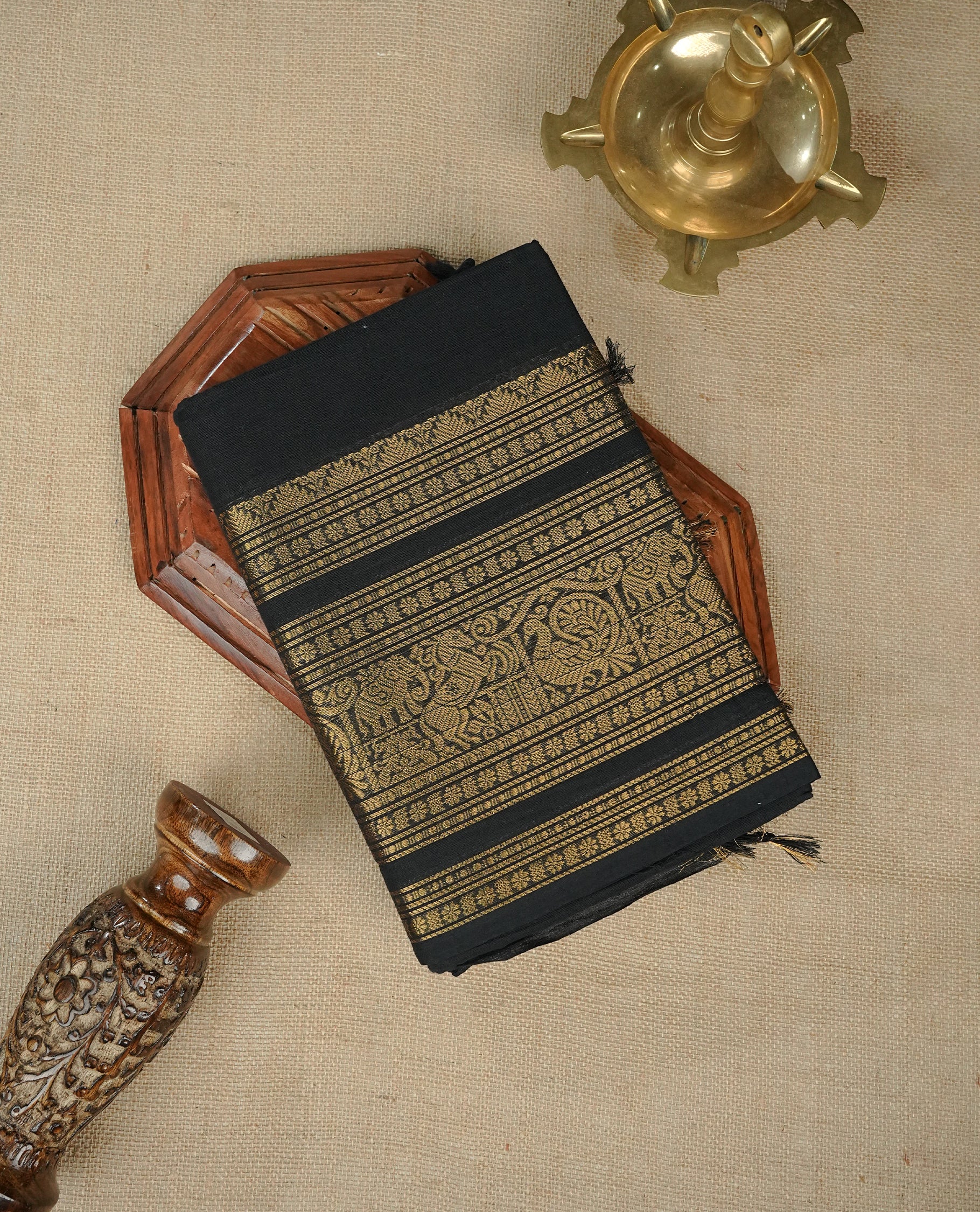 Black colour chettinad cotton saree featuring Elegant plain body, complemented by Self Colour with gold zari border, comes with matching blouse piece.