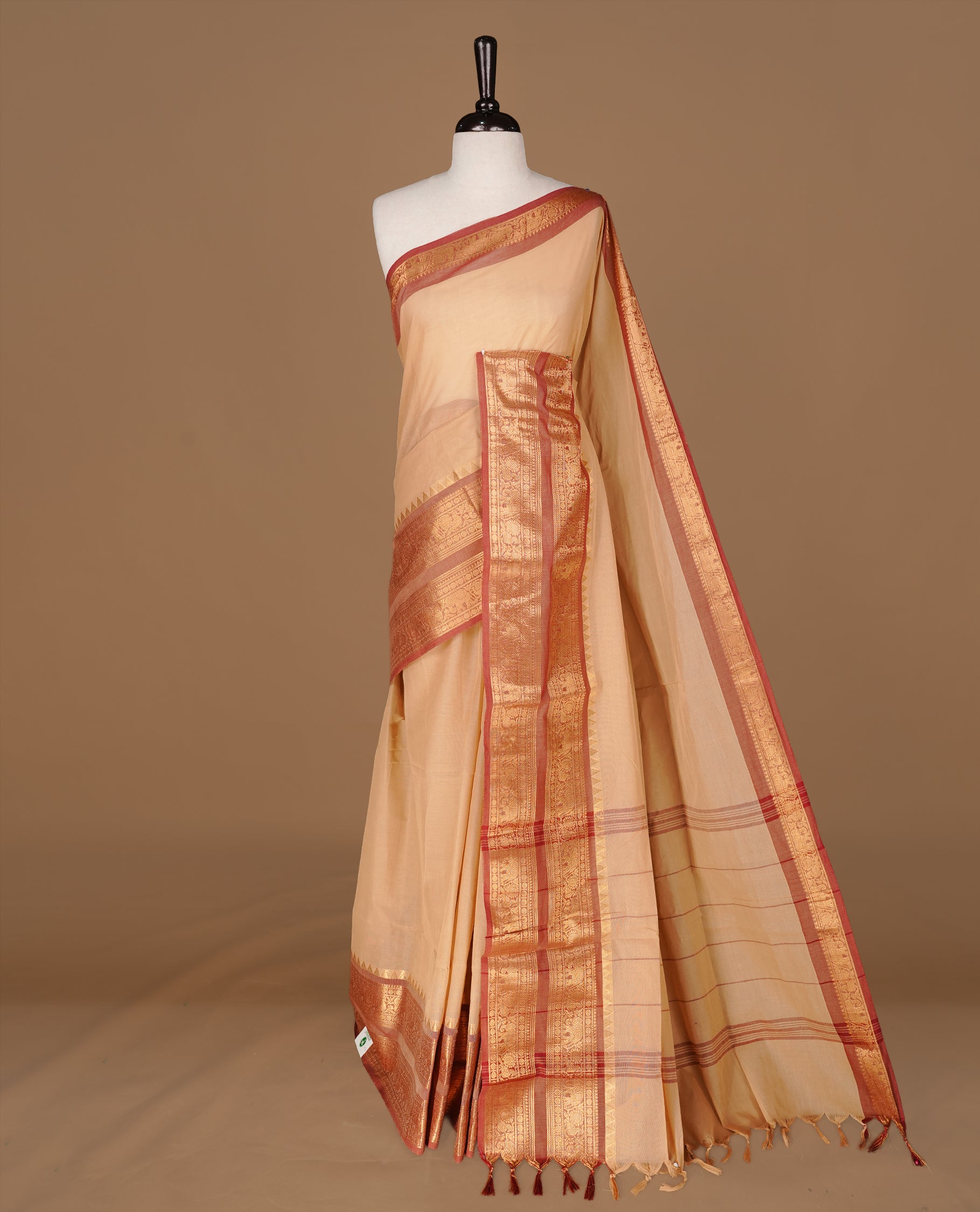 Sandalwood Colour chettinad cotton saree featuring Elegant plain body, complemented by contrast Brick red colour with gold zari border, paired with matching blouse.