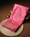 Pinkish red colour semi banaras tussar silk saree highlighting gold zari bird motifs on body, complemented by self colour with antique zari border, paired with matching blouse piece.