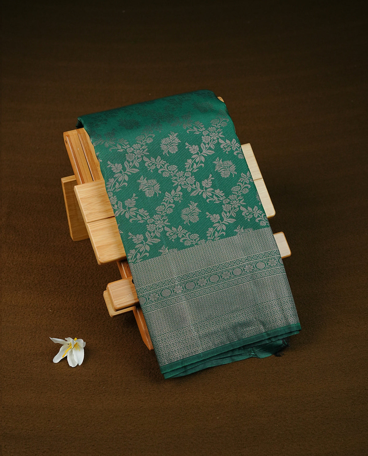 Dark green colour semi silk saree featuring antique zari kodi patterns on body, contrast self colour with traditional border on body, grand pallu comes with matching blouse piece