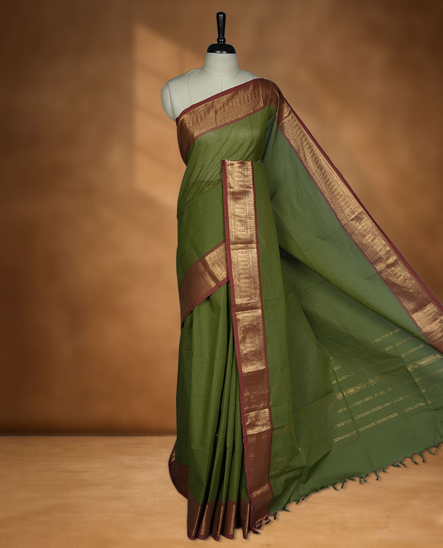 Olive green colour chettinad cotton saree featuring Elegant plain body, contrast Brick red colour border with gold zari border, pallu and paired with matching blouse.