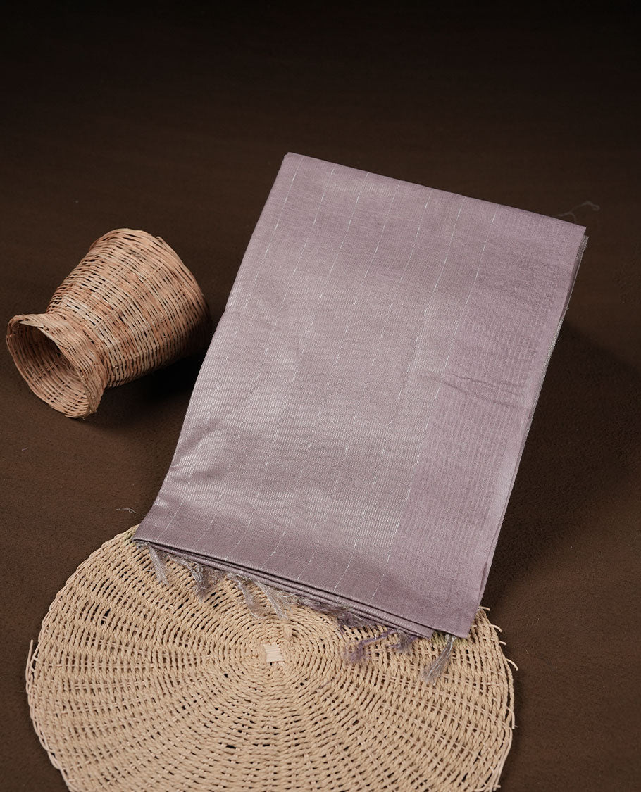 Light lavender colour semi jute saree highlighting gold zari striped body, without border and paired with matching blouse.