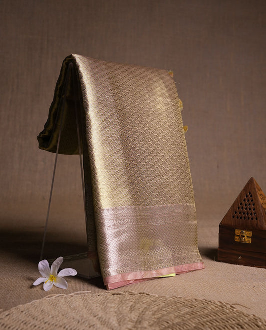 Dark Gold colour Pure banaras tissue silk saree featuring gold zari brocade design across body, with contrast peach colour with silver zari brocade border, finished with a matching blouse.