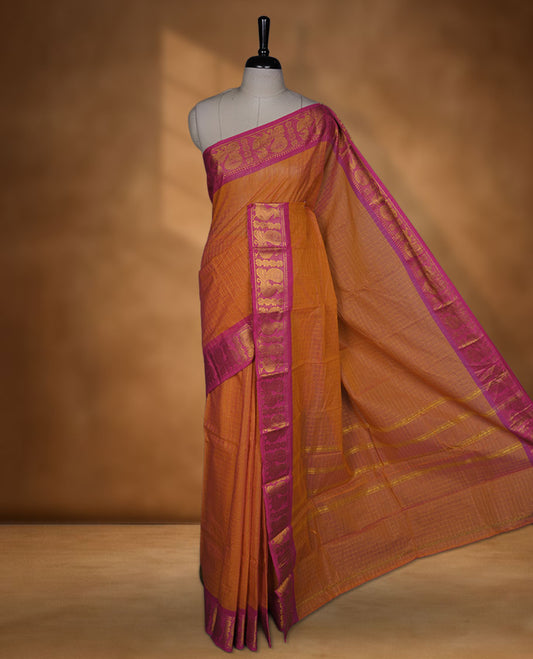 Orange colour chettinad cotton saree featuring gold zari check patterned body, contrast pink colour with traditional gold zari border paired without blouse.