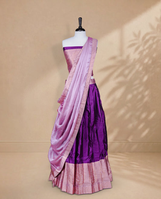 Purple colour Half saree featuring Plain skirt with Zari border on contrast Pink colour border, Unstitched Blouse and matching dupatta.