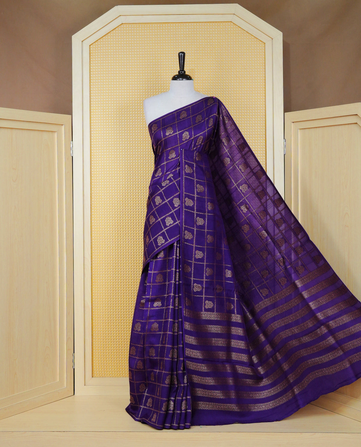 Violet colour semi banaras tussar georgette saree featuring gold zari check with motifs on body, no specific border and paired with matching blouse piece.