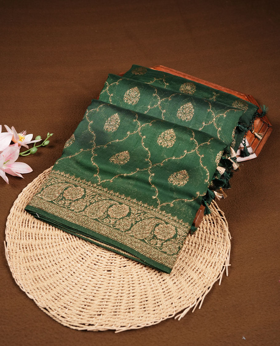 Deep forest green semi Banaras saree with gold zari buta motifs, finished with a traditional gold zari border and pallu, paired with a matching blouse.