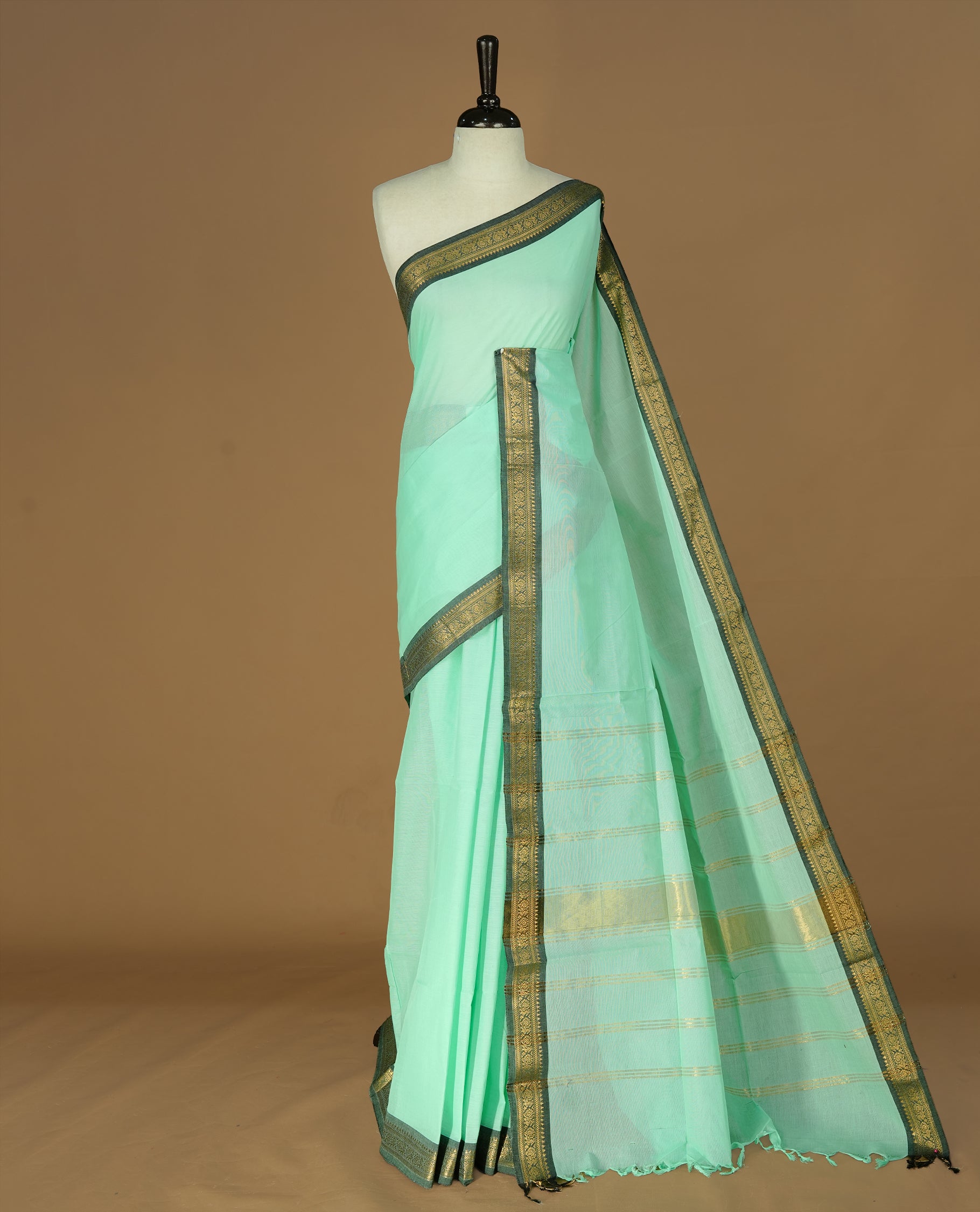 Mint Colour Chettinad cotton saree featuring elegant plain body , complemented by contrast Greyish black colour with simple  traditional border, comes with matching blouse piece.
