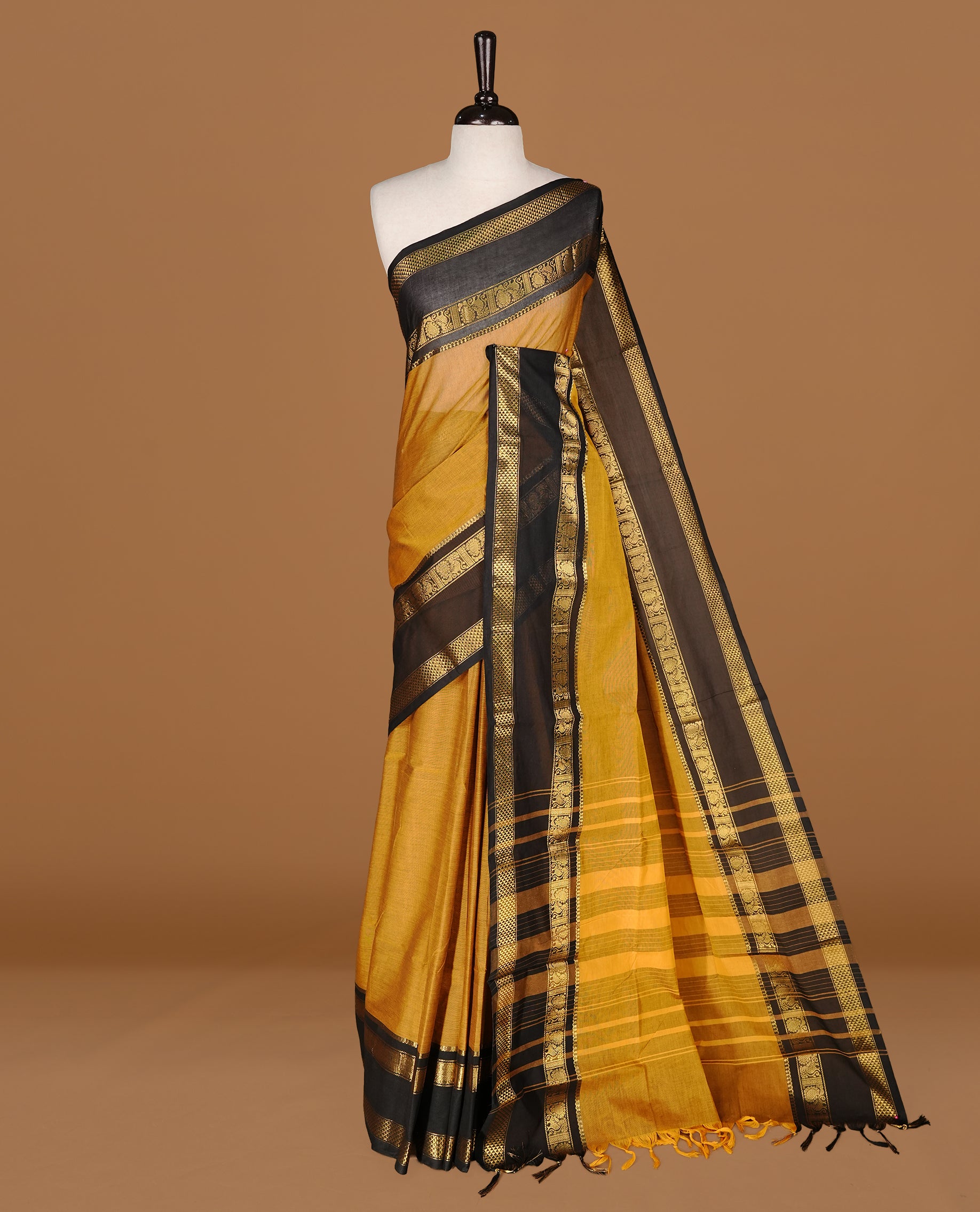 Mustard Colour Chettinad cotton saree featuring elegant plain body , complemented by contrast Black colour with traditional border, comes with matching blouse piece.