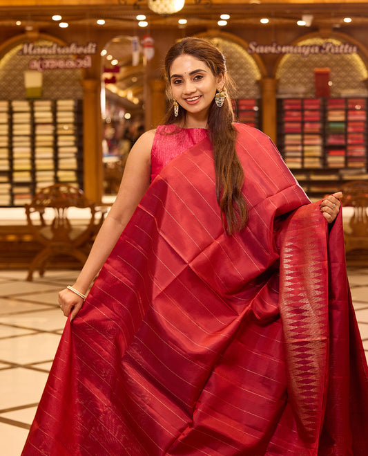 Brick red colour pure Mayuri Soft silk saree featuring a graceful striped body and a refined double temple border on one side, finished with a rich sheen and paired with a matching blouse