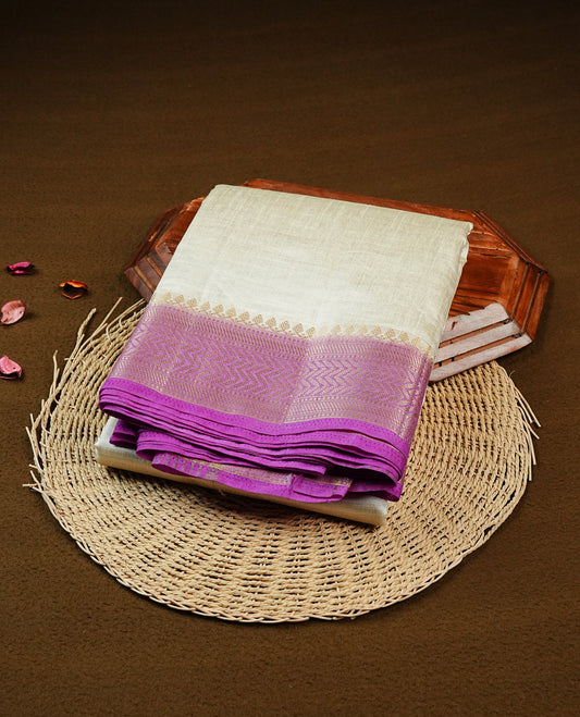 Off white Gold Tussar Saree Featuring elegant plain body, Complemented by contrast Purple colour with gold zari Border, comes with matching blouse piece.