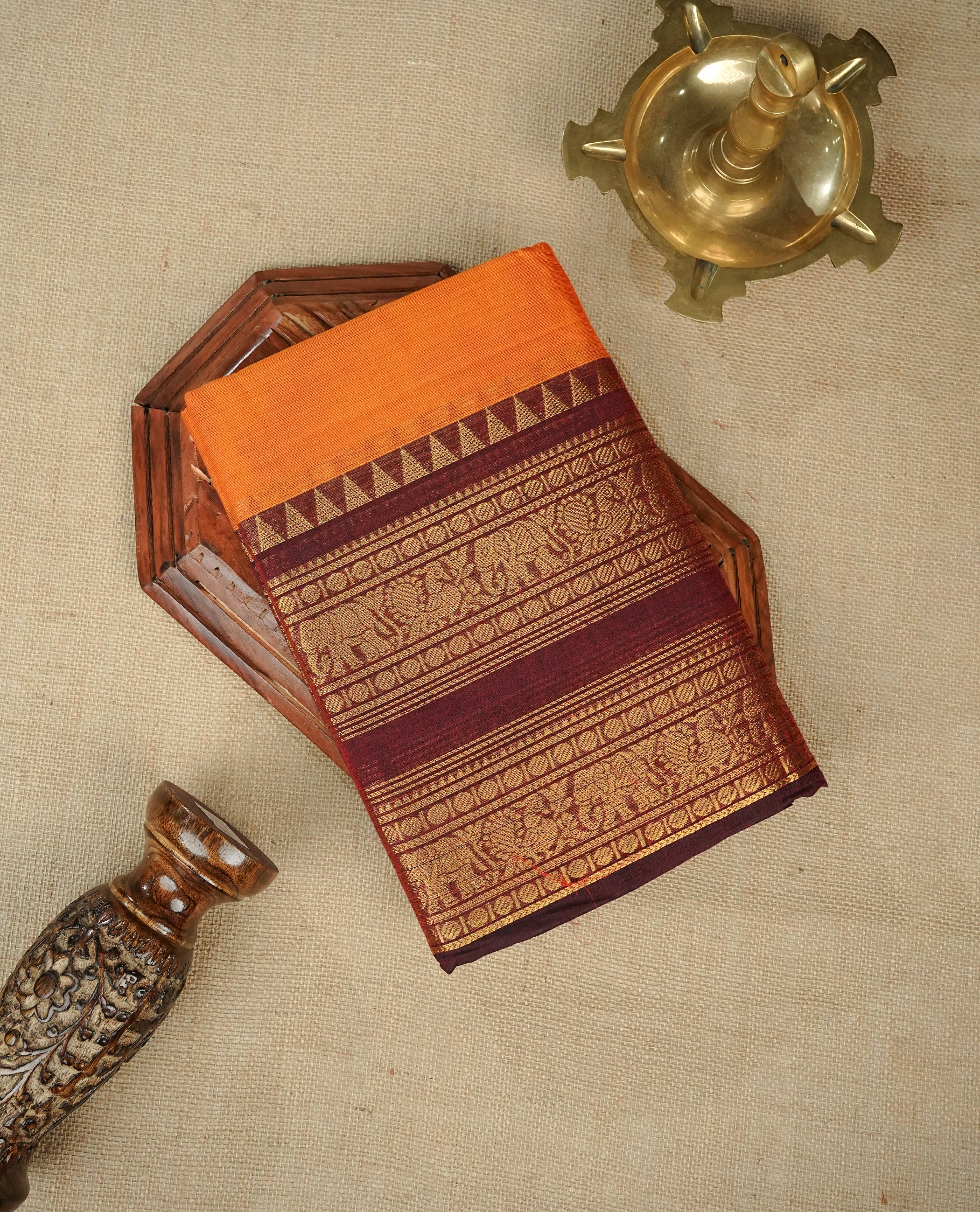 Orange colour chettinad cotton saree featuring Elegant plain body,contrast Maroon colour with Gold zari border, comes with matching blouse piece.