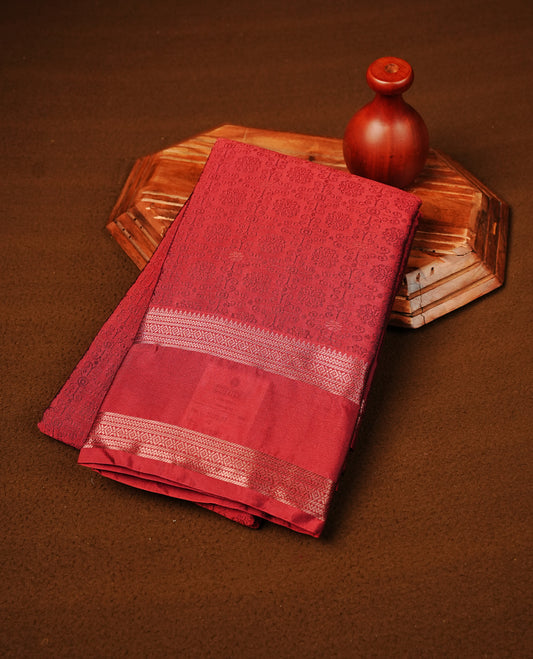 Crimson Red Colour  Semi Soft Slik  Saree Featuring An Elegant Self Floral Woven Body, Enhanced By A Traditional Rose Gold Zari Border And Rich Pallu, Paired With A Matching Blouse Piece.