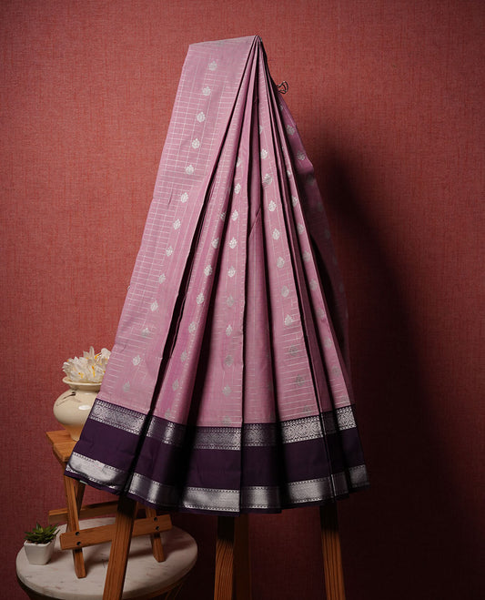 Lavender colour semi silk saree highlighting silver zari box pattern and motifs across body, featuring contrast silver colour border with gold zari pattern, comes with matching blouse .