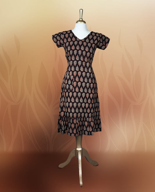 Brownish black colour nightwear with traditional block print motifs in red and beige, Features a V neck, short sleeves, and a stylish tiered flared hem, Perfect for festive events, casual wear, or cultural gatherings.
