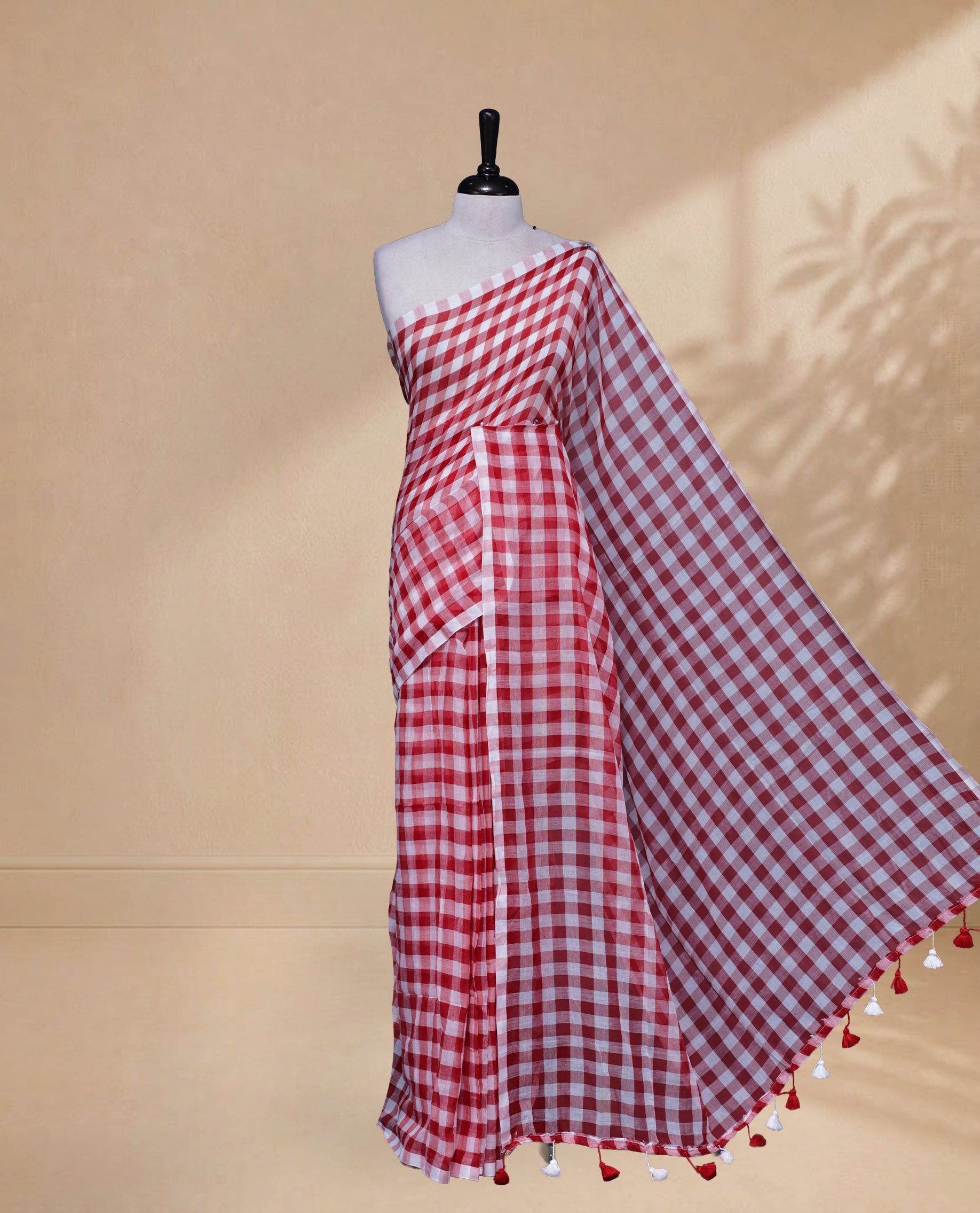 Red & White colour Khadi Mul cotton saree featuring Check Pattern on body,Enhanced Minimalist Borderless Finish & elegant Tassels at pallu.