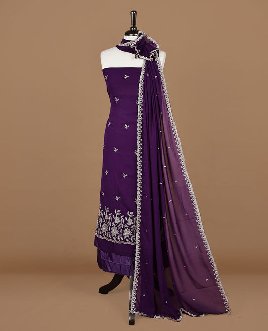 Purple colour churidhar material featuring gold thread floral pattern on body, paired with matching bottom & dupatta.