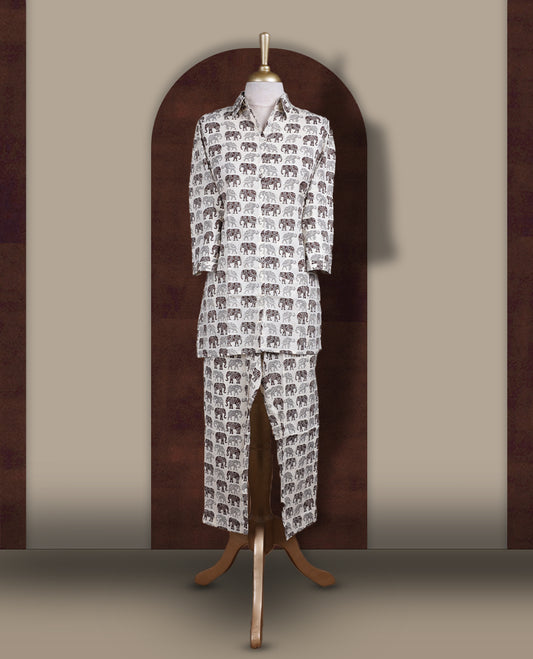 Off white colour cotton coord set featuring charming brown & grey colour elephant prints all over, Designed with a classic shirt collar and 3/4 sleeves, paired with matching straight pants for a trendy, relaxed, and comfy everyday look.