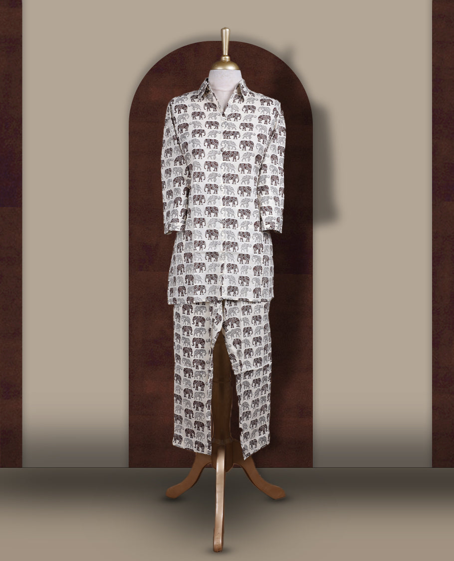 Off white colour cotton coord set featuring charming brown & grey colour elephant prints all over, Designed with a classic shirt collar and 3/4 sleeves, paired with matching straight pants for a trendy, relaxed, and comfy everyday look.