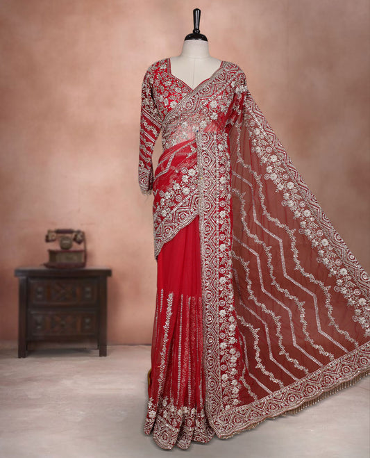 Red Colour net designer Wedding saree featuring all over floral embroidery with sequin detailing and an ornate scalloped border, finished with a matching embellished blouse.