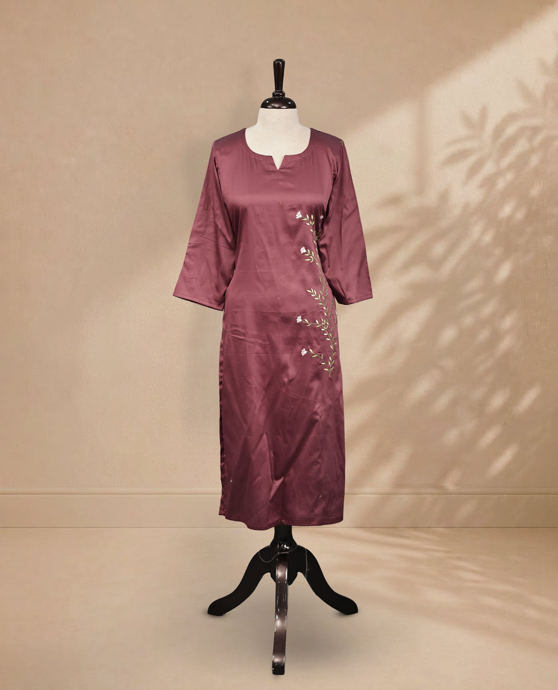 Old Plum kurti featuring a classic U-shaped neckline, delicate  floral vine embroidery on the body, and sleeves.