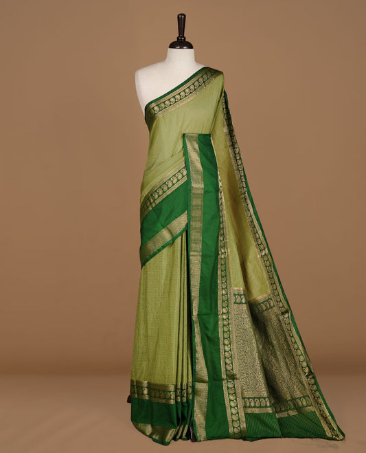 Pista colour semi georgette saree featuring gold zari check pattern on body, complemented by contrast green colour with zari border, paired with matching blouse piece.