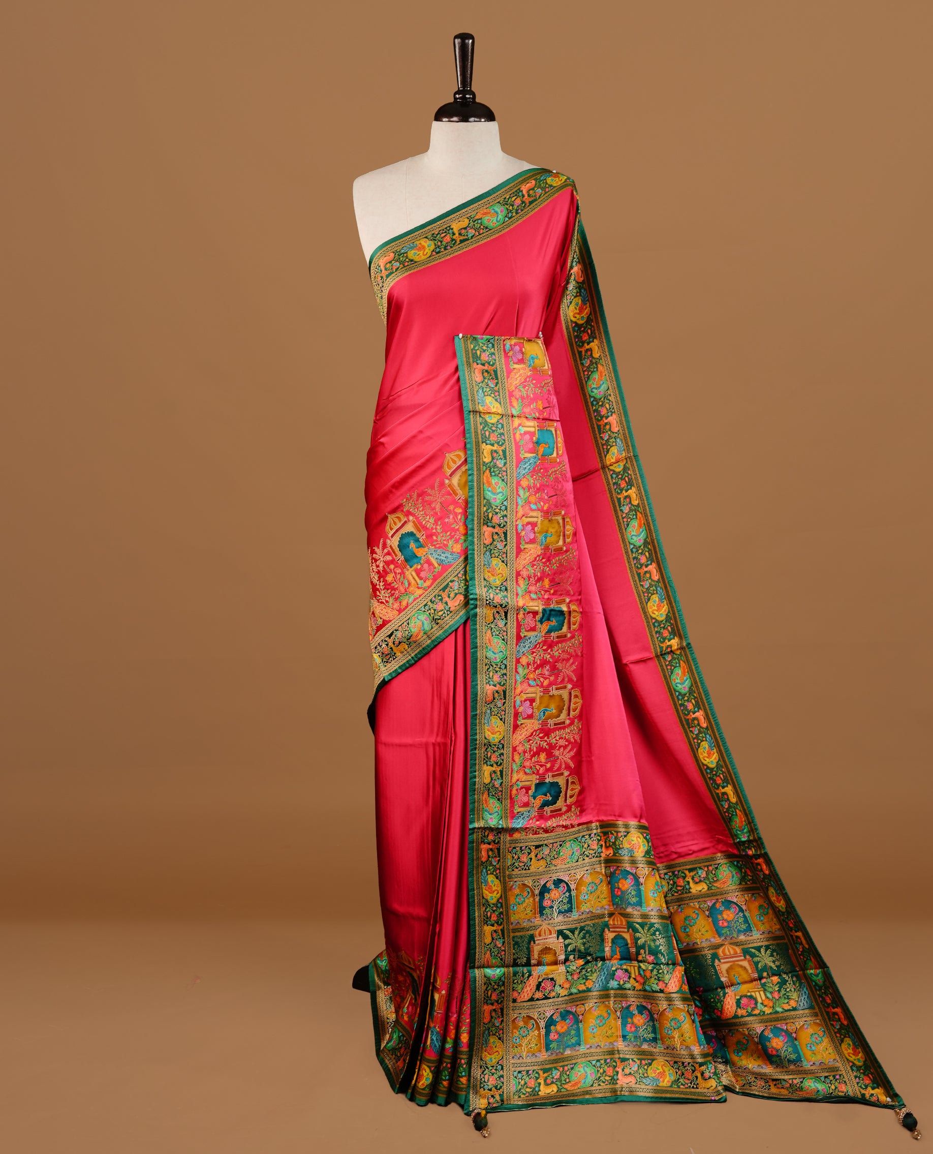 Pink colour Pashmina Saree featuring a plain lustrous body, a multicolour traditional woven border, a rich traditional woven pallu with architectural and floral motifs, paired with a matching pink blouse.