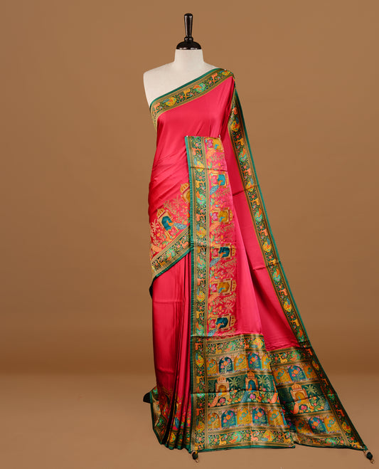 Pink colour Pashmina Saree featuring a plain lustrous body, a multicolour traditional woven border, a rich traditional woven pallu with architectural and floral motifs, paired with a matching pink blouse.