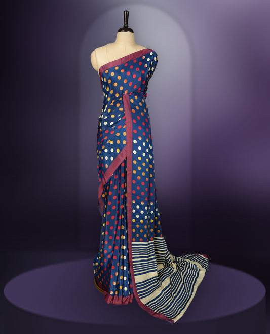 Blue colour saree with red, white & yellow motifs, diamond border, and bold pallu & Comes with a paired matching blouse.