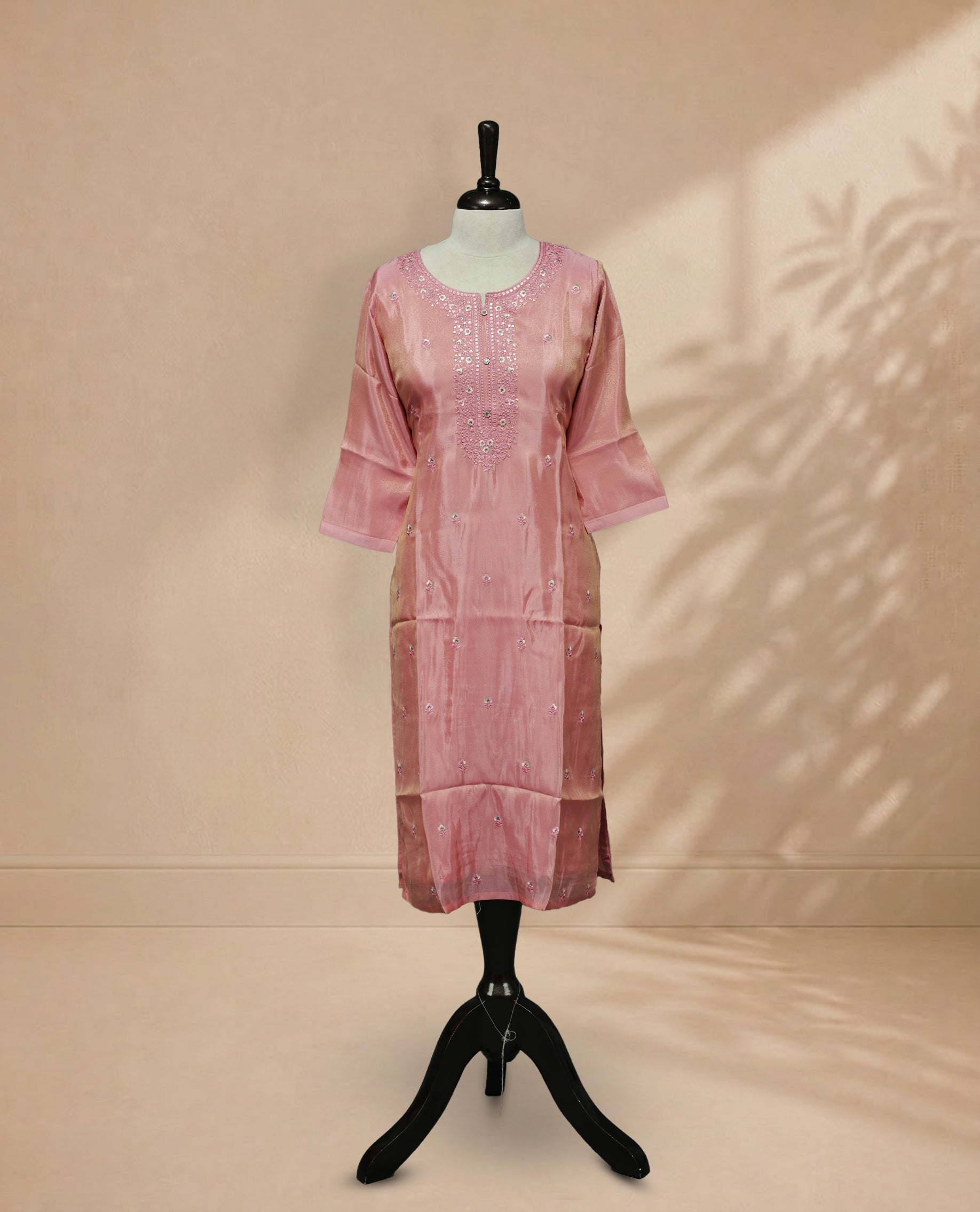 Peach Pink Kurti featuring floral threadwork across the body, a U-shaped neckline adorned with thread work, and a 3/4-sleeve design.