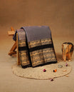 Lavender colour Kancheepuram silk saree featuring Gold zari check with Chakra Motifs on body, complemented by chocolate colour with Traditional border, comes with matching blouse piece.