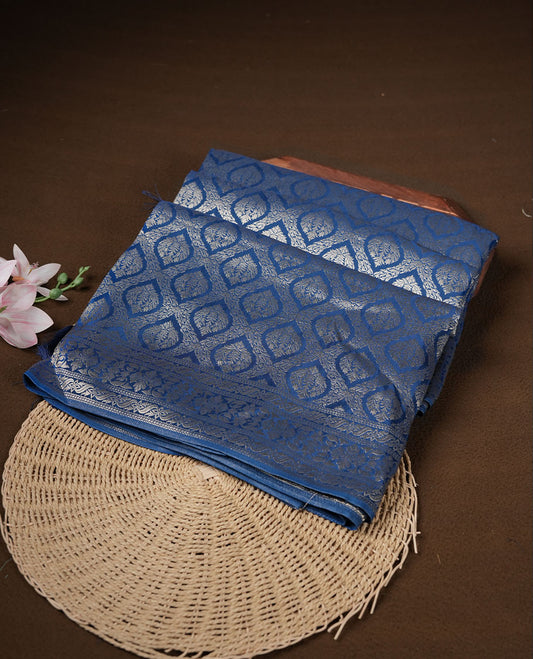 Dark blue colour banaras satin crepe saree featuring gold zari pattern across body, with self colour border with gold zari pattern and paired with matching blouse.