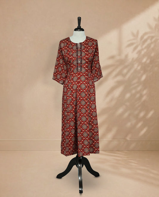 Brick Red Colour Kurti featuring digital floral prints on the body, a round neckline with embroidered detailing, and 3/4 sleeves Design.