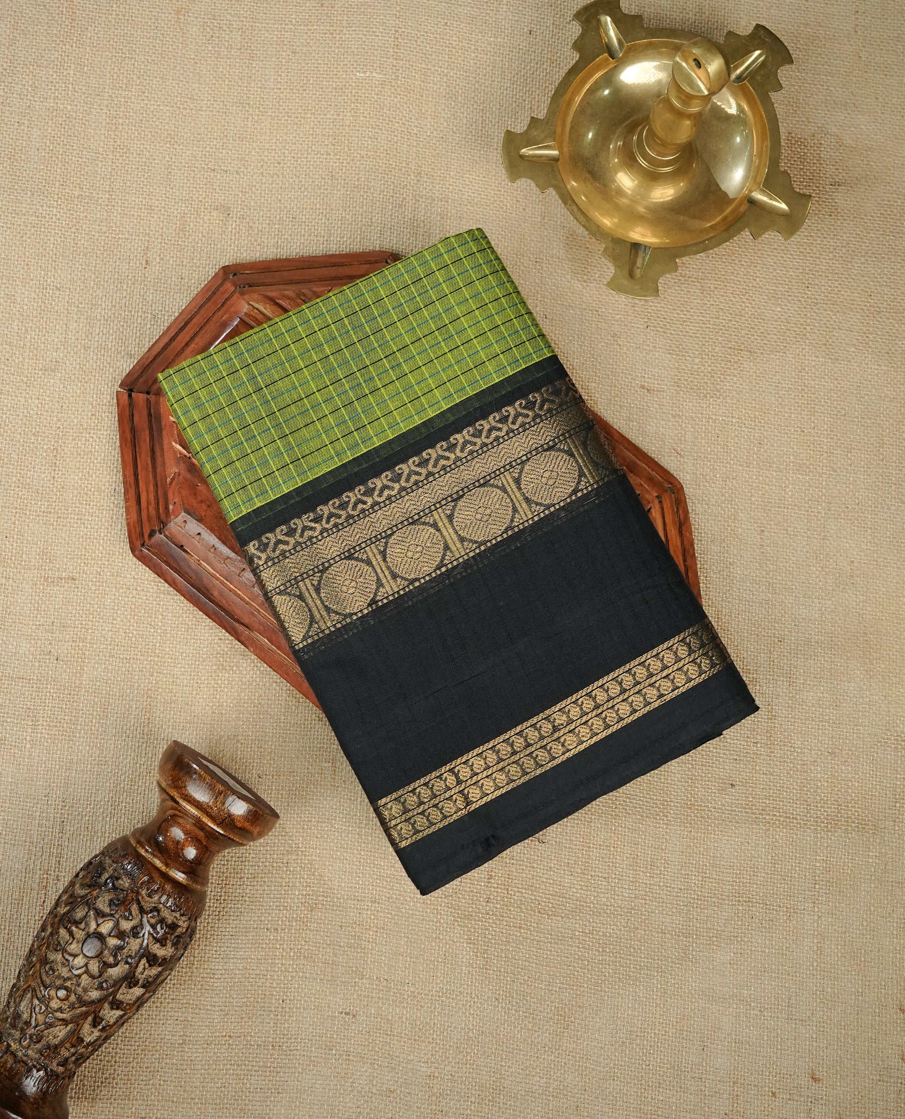 Green colour chettinad cotton saree featuring Strip pattern on body,contrast Black colour with Gold zari border, comes with matching blouse piece.